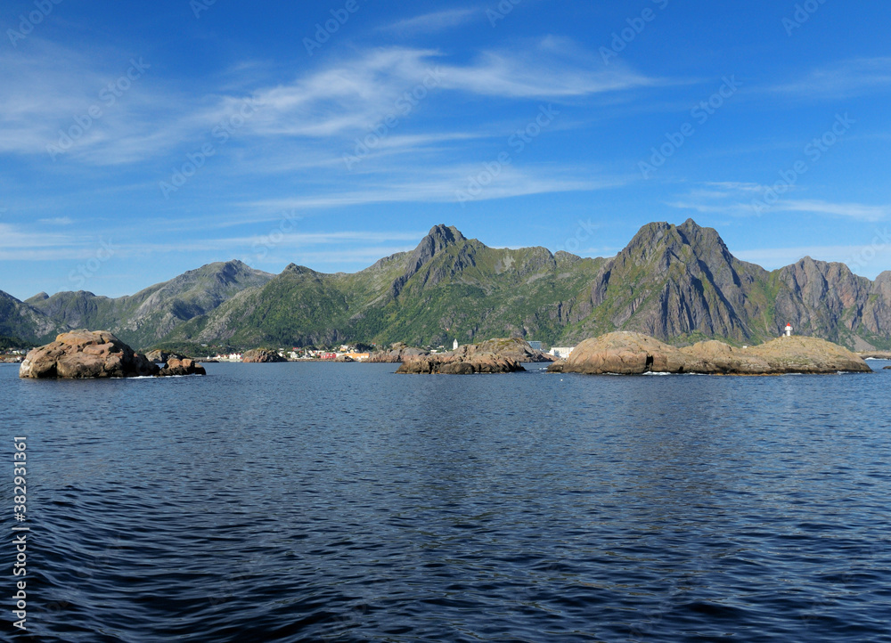 View From The Sea To The Mountains Of Lofoten Islands On A Sunny Summer Day With A Clear Blue Sky And A Few Clouds