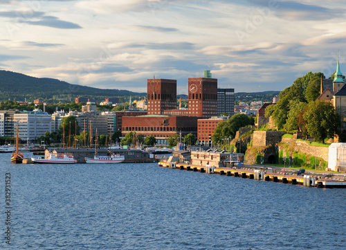 View From Oslofjord To The Red Brickstone City Hall In The Harbour Of Oslo On A Sunny Summer Day With A Clear Blue Sky And A Few Clouds