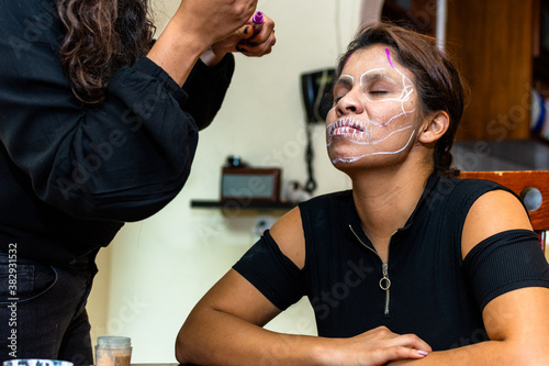 woman putting makeup on another woman