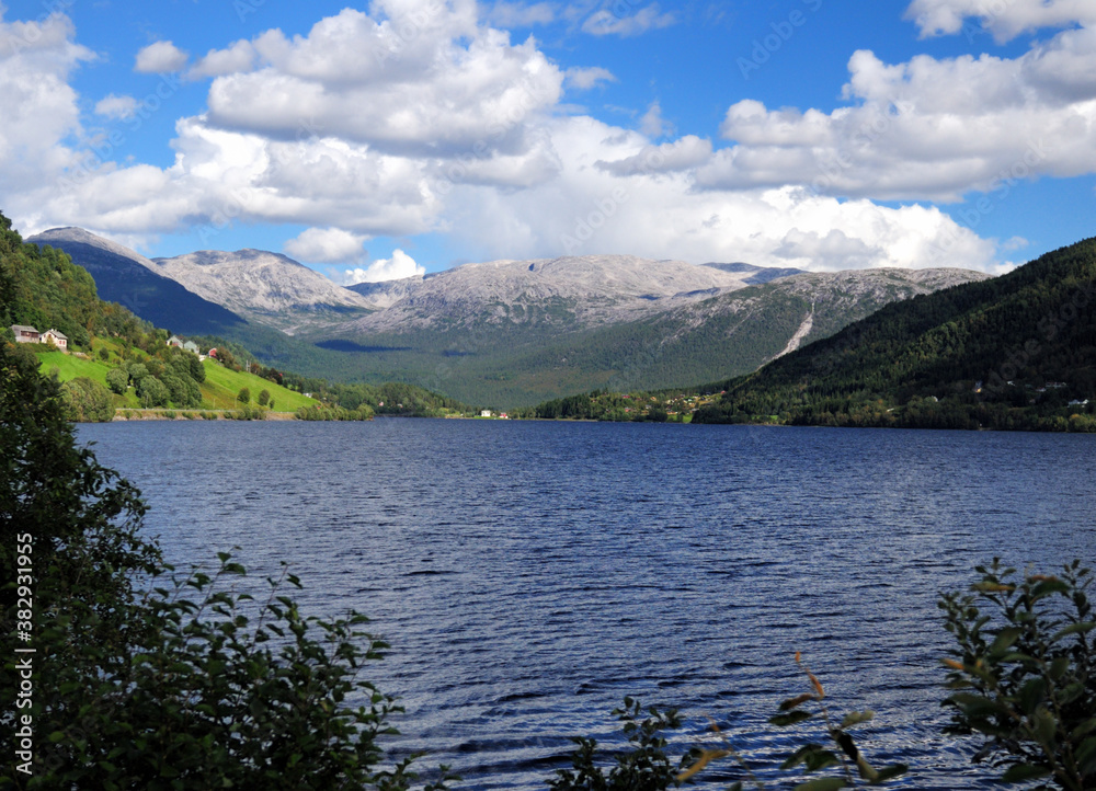 Scenic Landscape At Lake Oppheimsvatnet On A Sunny Summer Day With A Clear Blue Sky And A Few Clouds