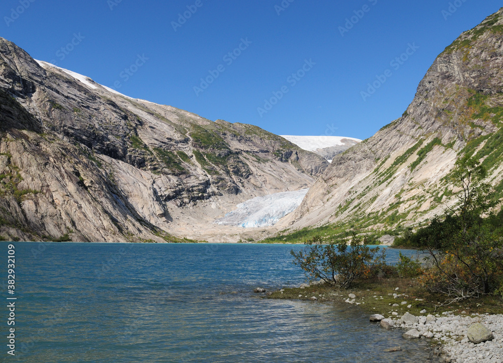 View From The Lake Nigardsbrevatnet To The Glacier Nigardsbreen In Jostedalsbreen National Park On A Sunny Summer Day With A Clear Blue Sky