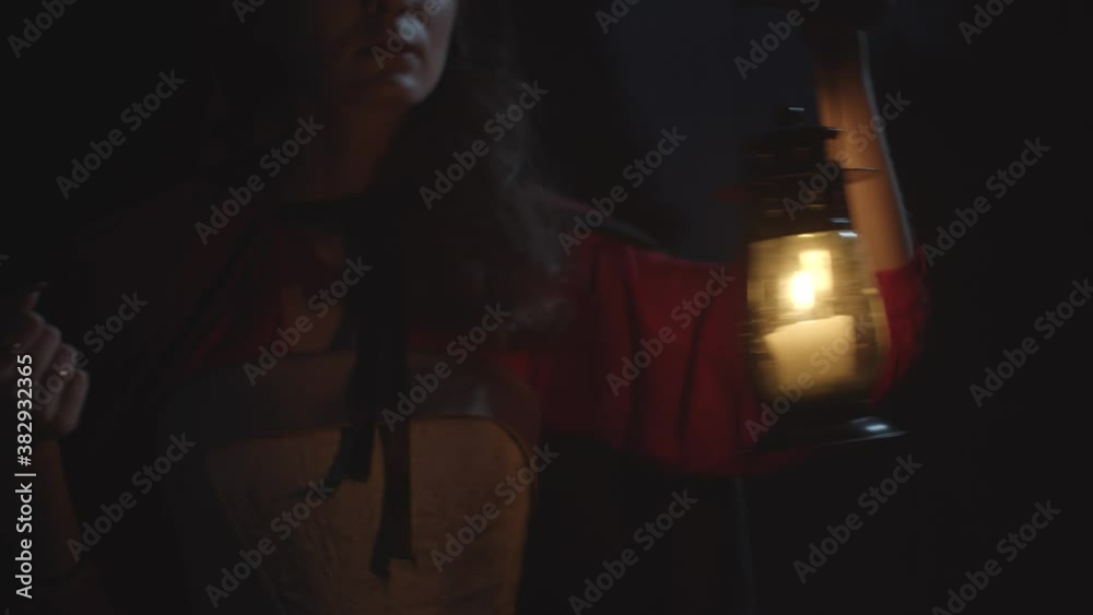 Red riding hood in dark woods with lantern, slow motion Red riding hood in dark woods with lantern, slow motion