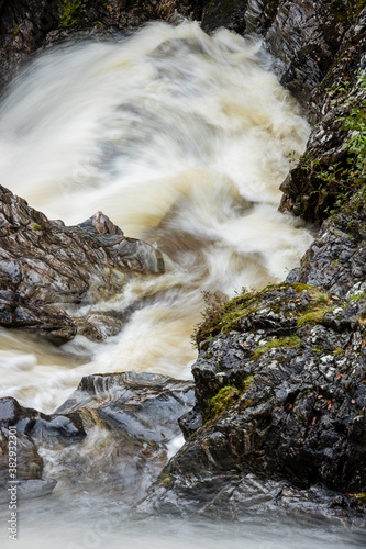 shot of Eas Chia-Aig waterfalls in Glen Chia-Aig near Achnacarry, Gairlochy and Fort William in the argyll region of the highlands of Scotland during autumn after heavy rainfall photo