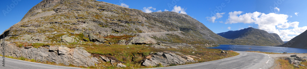 Panorama View Of The Barren Landscape On The Way To Dalsnibba Near Geiranger On A Sunny Summer Day With A Clear Blue Sky And A Few Clouds