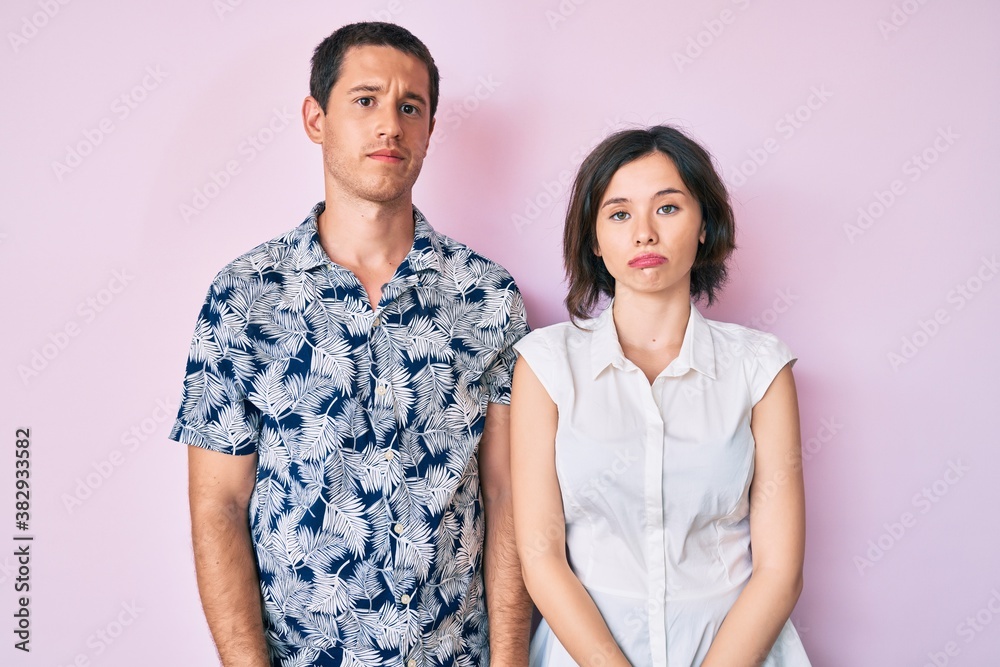 Beautiful couple wearing casual clothes looking sleepy and tired, exhausted for fatigue and hangover, lazy eyes in the morning. Beautiful couple wearing casual clothes looking sleepy and tired, exhausted for fatigue and hangover, lazy eyes in the morning.