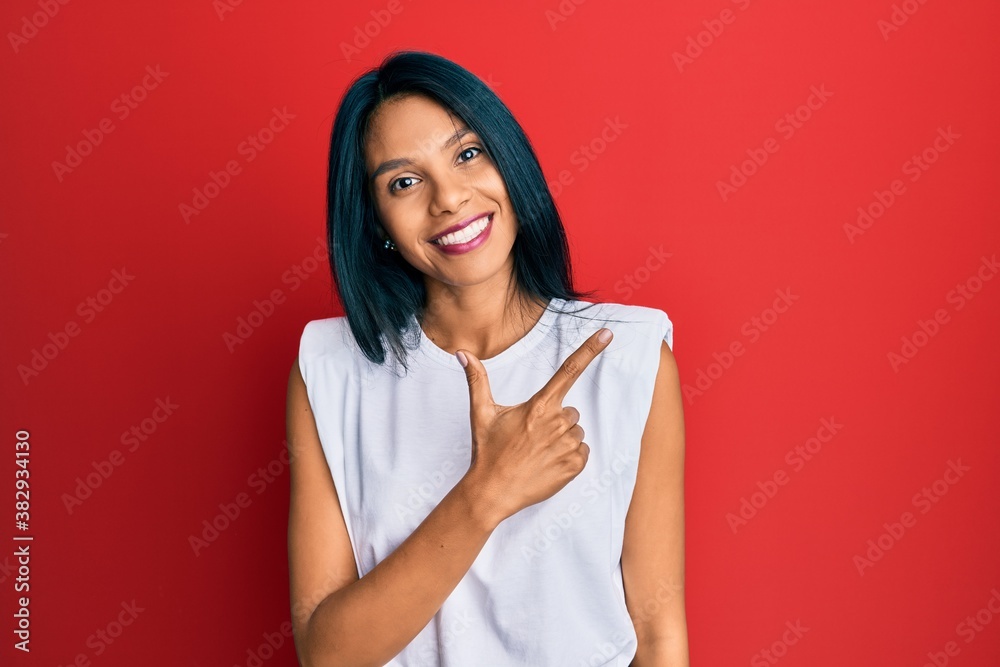 Young african american woman wearing casual clothes smiling cheerful pointing with hand and finger up to the side Young african american woman wearing casual clothes smiling cheerful pointing with hand and finger up to the side