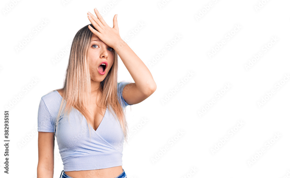 Young beautiful blonde woman wearing casual clothes surprised with hand on head for mistake, remember error. forgot, bad memory concept. Young beautiful blonde woman wearing casual clothes surprised with hand on head for mistake, remember error. forgot, bad memory concept.