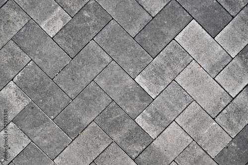 Pavement laid in hashed concrete blocks pattern.