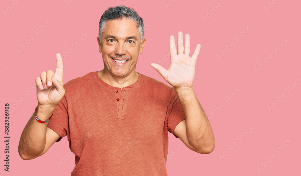 Handsome middle age man wearing casual clothes showing and pointing up with fingers number six while smiling confident and happy. Handsome middle age man wearing casual clothes showing and pointing up with fingers number six while smiling confident and happy.