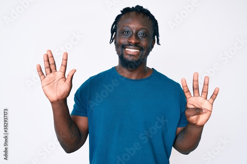 Young african american man with braids wearing casual clothes showing and pointing up with fingers number nine while smiling confident and happy.