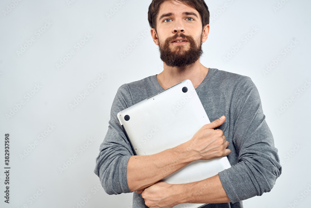 Man with laptop in hands technology internet self-confidence light background Man with laptop in hands technology internet self-confidence light background