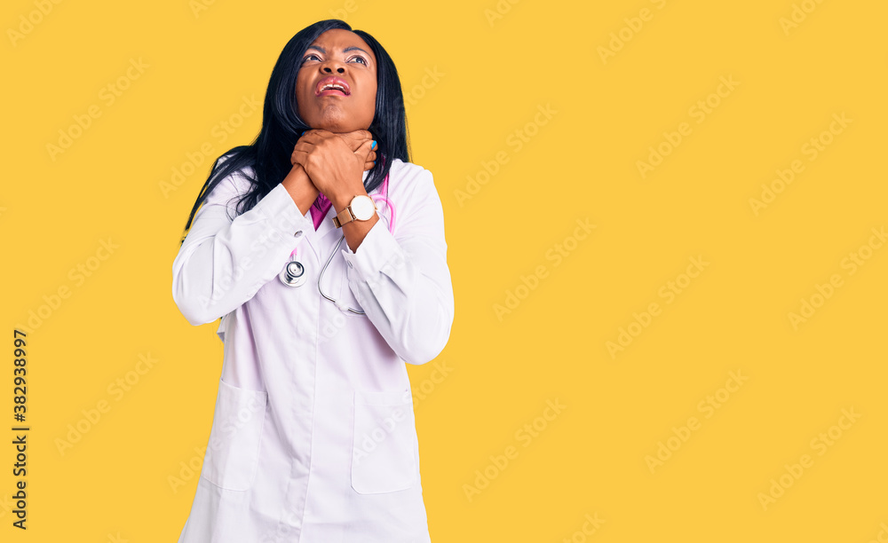Young african american woman wearing doctor stethoscope shouting suffocate because painful strangle. health problem. asphyxiate and suicide concept.
