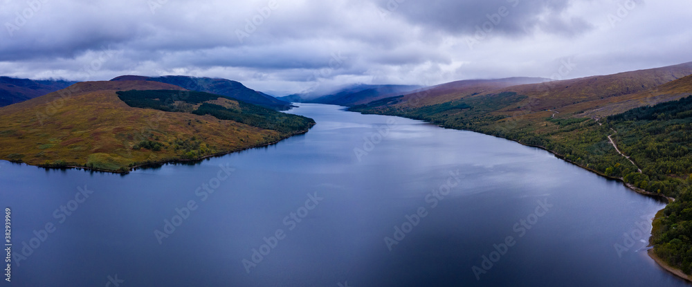 Naklejka premium shot of loch arkaig in the argyll region of the highlands of scotland during autumn on a clear bright day showing calm waters on the inland loch