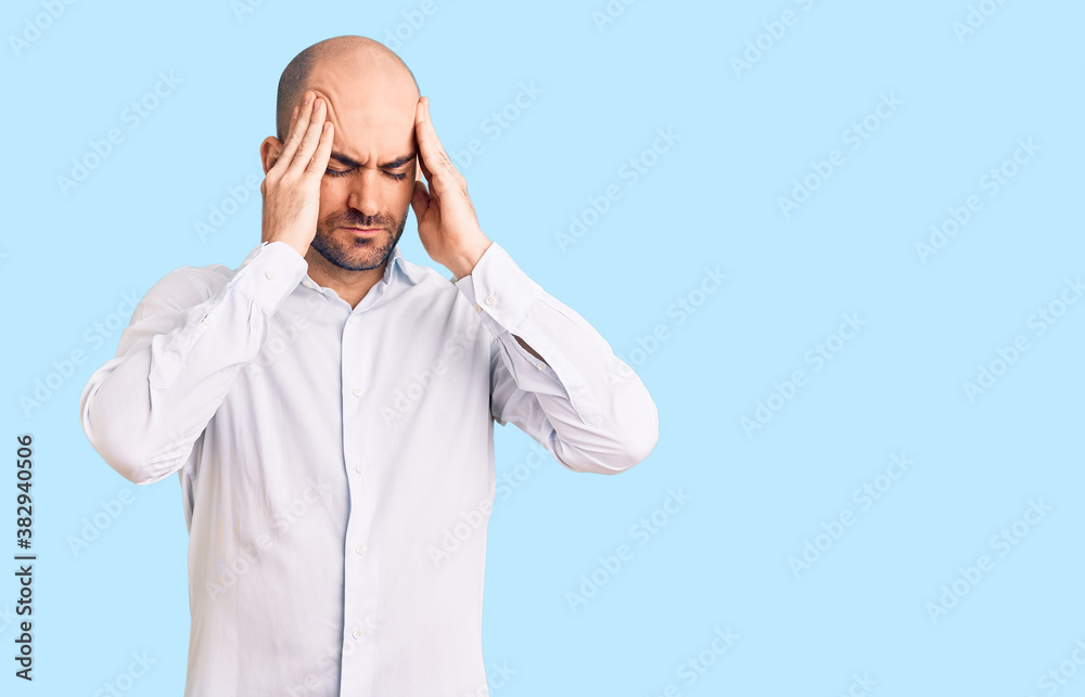 Young handsome man wearing elegant shirt suffering from headache desperate and stressed because pain and migraine. hands on head.