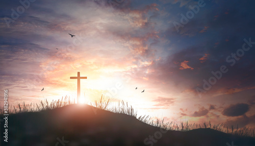Thanksgiving concept: Religious cross silhouette against a bight sunrise sky