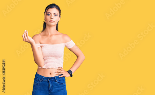 Young beautiful woman wearing casual clothes doing italian gesture with hand and fingers confident expression