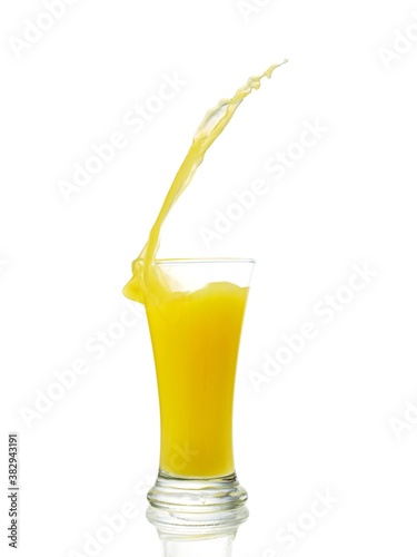 splashing orange juice with oranges isolated on white