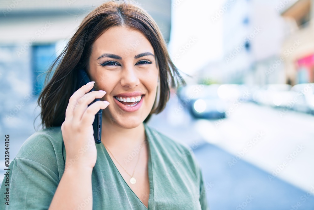 Young hispanic woman smiling happy talking on the smartphone walking at street of city Young hispanic woman smiling happy talking on the smartphone walking at street of city