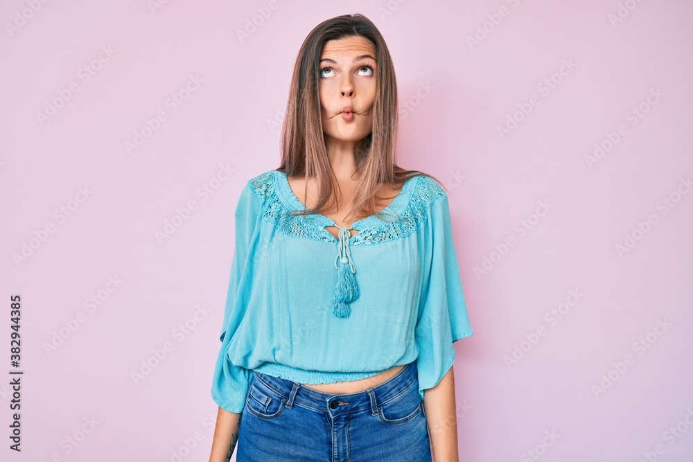 Beautiful caucasian woman wearing casual clothes making fish face with lips, crazy and comical gesture. funny expression. Beautiful caucasian woman wearing casual clothes making fish face with lips, crazy and comical gesture. funny expression.