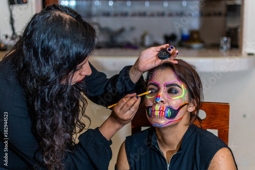 woman putting makeup on another woman