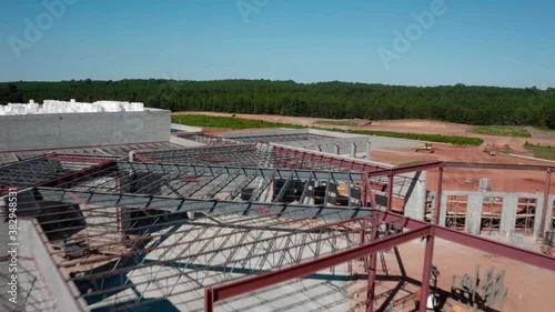 Aerial footage of a large building under construction with nobody on the job site