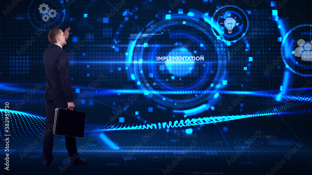 Business, technology, internet and network concept. Young businessman thinks over the steps for successful growth: Implementation Business, technology, internet and network concept. Young businessman thinks over the steps for successful growth: Implementation