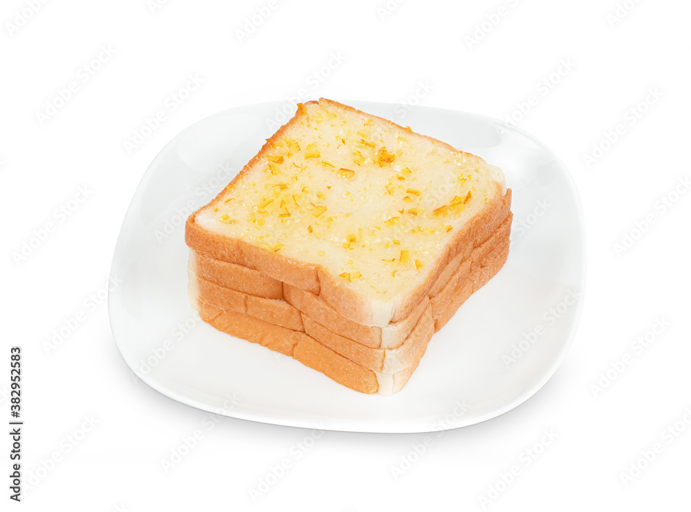 Bread sliced with orange jam spread on dish isolated on white background ,include clipping path Bread sliced with orange jam spread on dish isolated on white background ,include clipping path