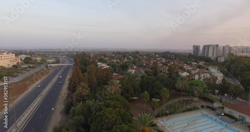 Sparse Traffic on Main Road near Ben Gurion Airport, Yehud, Israel. Static Aerial View During Covid 19, Virus Pandemic Outbreak, Twilight Above Suburbia and Horizon. Can be Generic photo