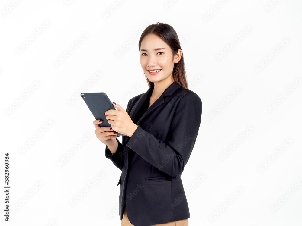 Portrait of young beauty Asian Businesswoman in black suit holding and using tablet.