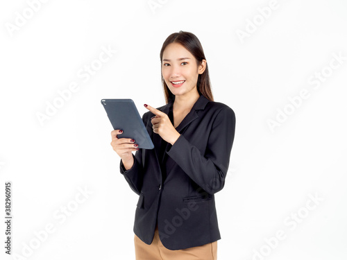 Portrait of young beauty Asian Businesswoman in black suit holding and using tablet.