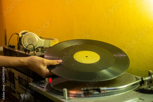 hands placing a record on the turntable