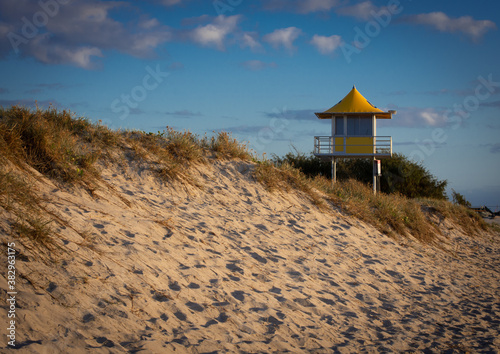 An Australian Surf Lifesavers Tower with blue sky and beach in foreground