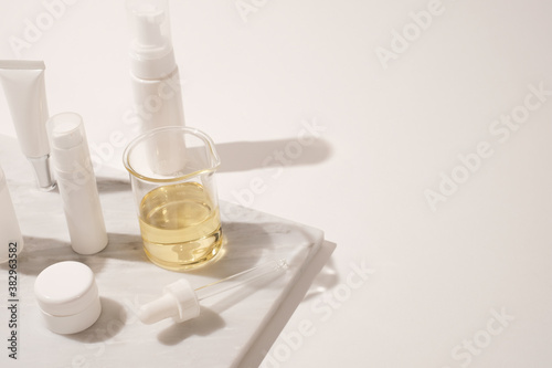 cosmetic and skin care for beauty routine on white background with shadow. modern and minimal product design with essential oil, pestle and mortar.