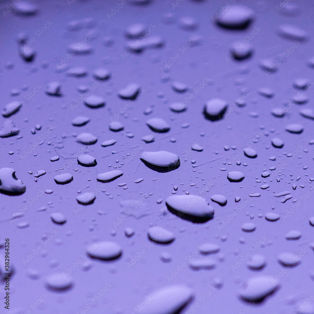 Water drop on mirror reflection with light made mor color blue green violet.