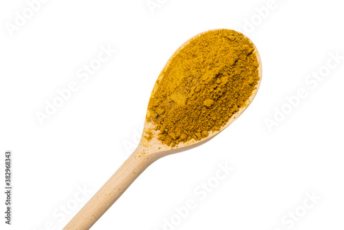 Curry in wooden spoon isolated on white.