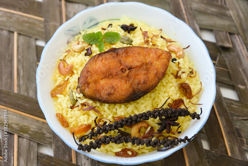 Fish biryani. Spicy Indian Malabar biryani or Hydrabadi biryani, Dum Biriyani,  fish and rice. pulao basmati rice, spicy mixed rice dish with meat curry for Ramadan Kareem, Eid