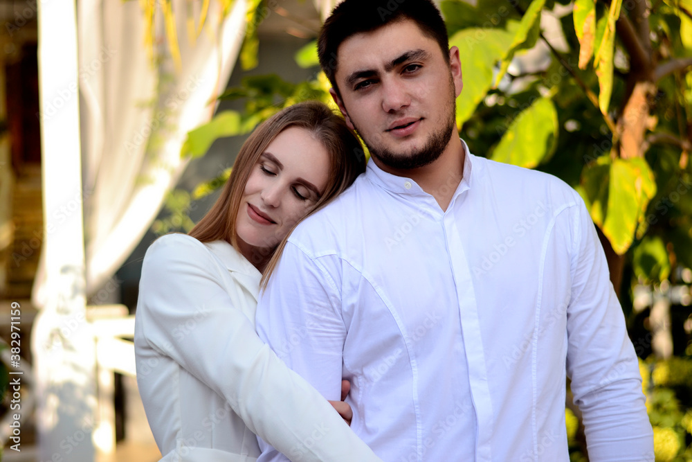 Fototapeta premium Young guy with a girl in white clothes