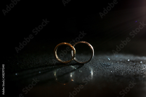 wedding rings on a black background