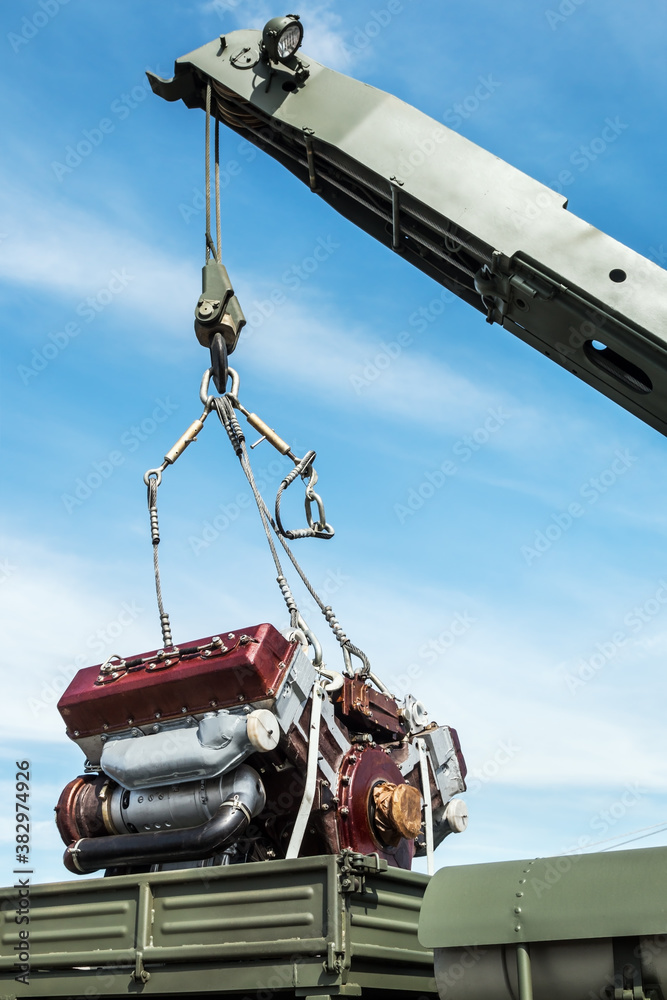 the crane boom raises or lowers the engine for replacement or repair the crane boom raises or lowers the engine for replacement or repair