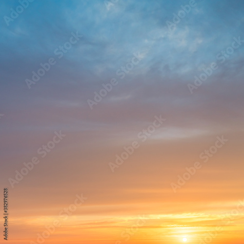 Fototapeta Naklejka Na Ścianę i Meble -  Orange and blue clouds at sunrise
