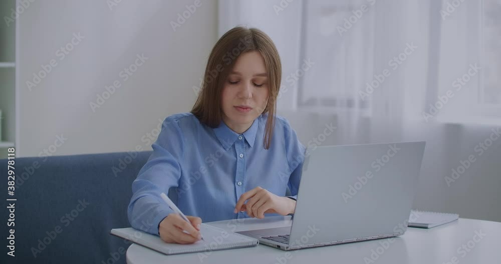 middle-aged woman is talking online by video call on notebook, sitting at home, modern technology of communication middle-aged woman is talking online by video call on notebook, sitting at home, modern technology of communication
