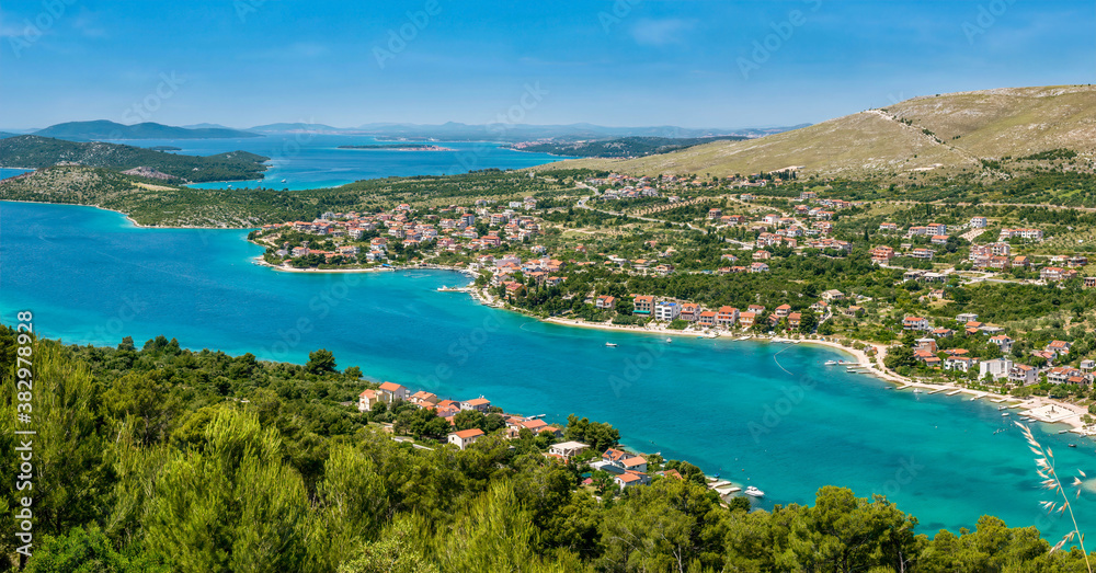 Panoramic view of the beautiful coastline of the Adriatic Sea and coastal resort town of Grebastica, Croatia, situated on a long bay between Split and Sibenik, viewed from the D8 highway.