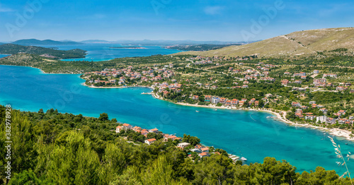 Panoramic view of the beautiful coastline of the Adriatic Sea and coastal resort town of Grebastica, Croatia, situated on a long bay between Split and Sibenik, viewed from the D8 highway.