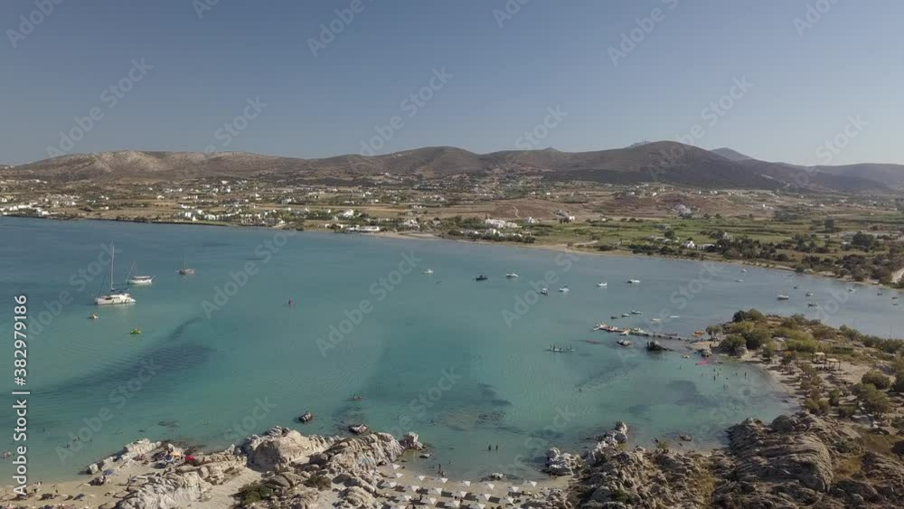 Aerial drone video of sandy beach blue sea water, clear blue sky Paros island Cyclades, Greece Aerial drone video of sandy beach blue sea water, clear blue sky Paros island Cyclades, Greece