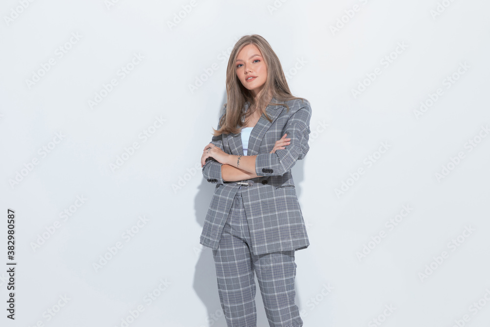 Positive fashion businesswoman smiling with hands crossed and standing Positive fashion businesswoman smiling with hands crossed and standing