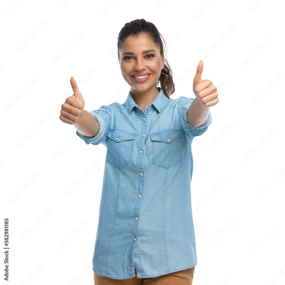 Positive smart casual woman gesturing ok with both hands, smiling