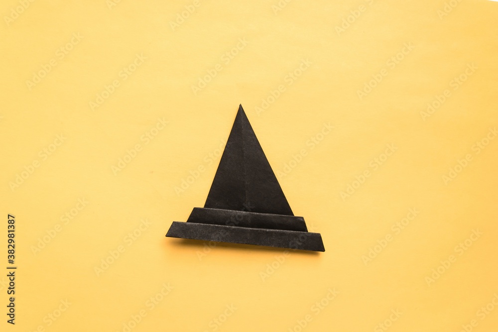 Fototapeta premium Step by step photo instruction how to make origami paper hat. Halloween hat of witch. Simple diy with kids children's concept.