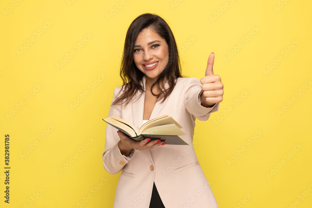 happy young businesswoman reading book and smiling happy young businesswoman reading book and smiling