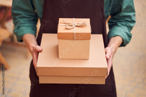 Close up shot of man holding gift boxes © Yakobchuk Olena