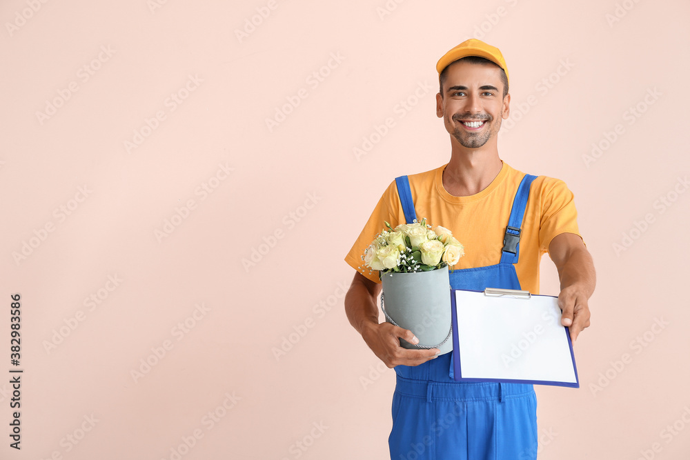 Delivery man with bouquet of flowers and clipboard on color background Delivery man with bouquet of flowers and clipboard on color background